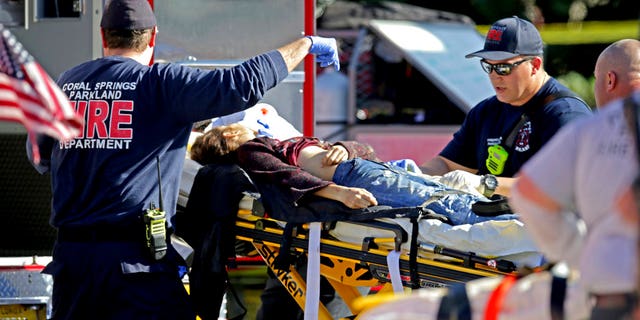 Medical personnel tend to a victim following a shooting at Marjory Stoneman Douglas High School.