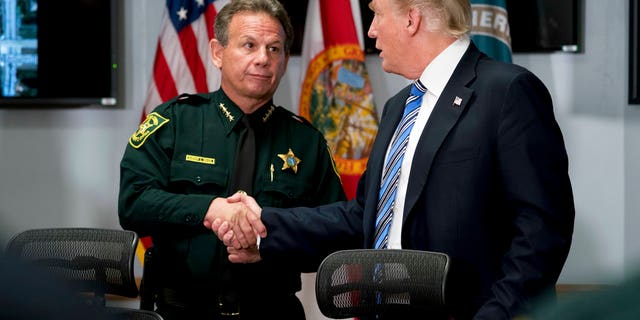 Feb. 16, 2018: President Trump shakes hands with Broward County Sheriff Scott Israel as he meets with law enforcement officers at the Broward County Sheriff's Office in Pompano Beach, Fla.