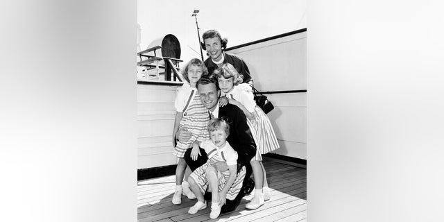 In this July 7, 1954 photo, Evangelist Billy Graham poses with his his wife, Ruth, and their three daughters on the Queen Mary following his arrival in New York.
