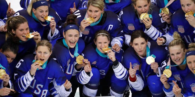Untied States hockey team celebrate with their gold medals.