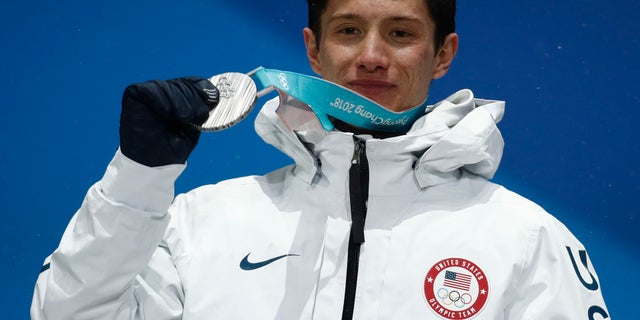 Silver medalist in the men's halfpipe Alex Ferreira, of the United States, poses during the medals ceremony.