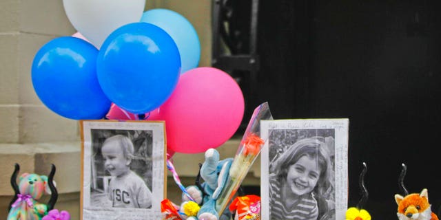 In this Oct. 27, 2012, file photo, photographs of 6-year-old Lucia Krim and her 2-year-old brother, Leo, are displayed alongside balloons and stuffed animals at a memorial outside the apartment building where they lived in New York.