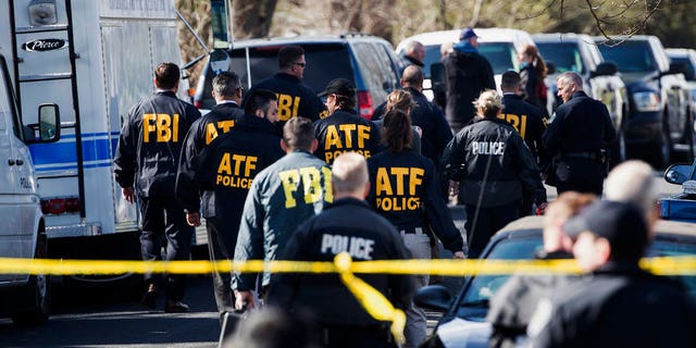 Authorities work on the scene of an explosion in Austin on Monday, March 12, 2018.