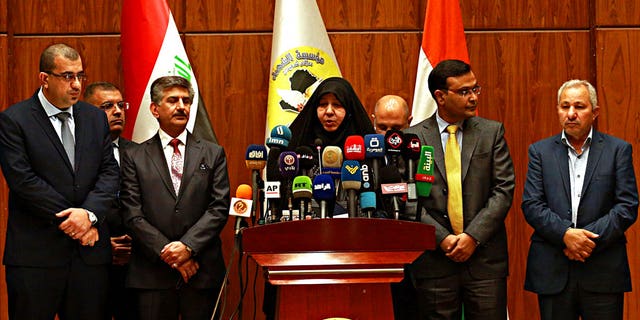 Najiha Abdul-Amir al-Shimari, center, the head of Iraq's Martyrs Establishment speaks during a press conference, in Baghdad, Iraq, Tuesday, March 20, 2018. Al-Shimari said Tuesday, that the bodies of 38 of the 39 Indians abducted by the Islamic State group in 2014 were found in a mass grave outside Mosul.
