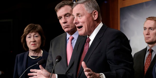 Senate Intelligence Committee Chairman Sen. Richard Burr, R-N.C., center, joined from left by, Sen. Susan Collins, R-Maine, Vice Chairman Mark Warner, D-Va., and Sen. James Lankford, R-Okla., previews some of the panel's recommendations for improving the nation's election infrastructure ahead of the 2018 midterm elections, during a news conference in Washington, March 20, 2018.