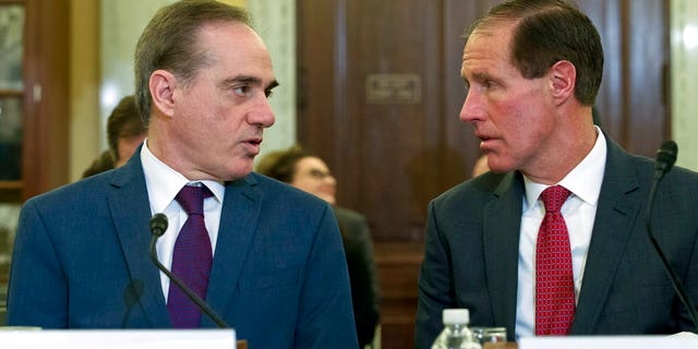 Veterans Affairs Secretary David Shulkin, left, speaks with Chief Financial Officer of the Department of Veterans Affairs Jon Rychalski during a hearing on budgets for veterans programs, before the Senate Committee on Veterans Affairs on Capitol Hill.