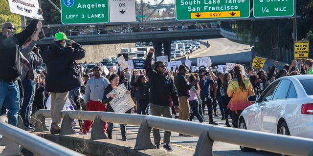 Hundreds of protesters march in Sacramento, Calif., disrupting rush hour traffic, to protest a police fatal shooting of an unarmed black man.