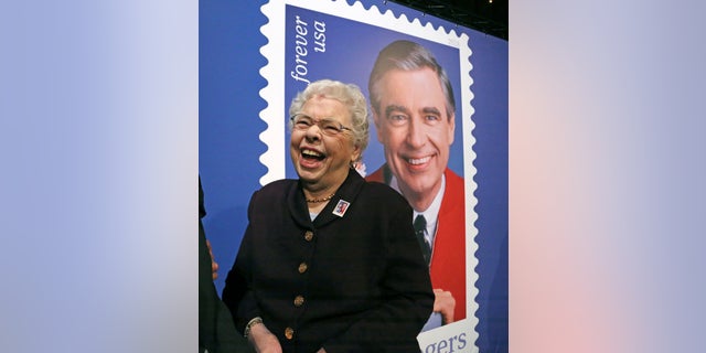 Fred Rogers wife, Joanne Rogers, shares a laugh with friends in front of a giant Mister Rogers Forever Stamp following the first-day-of-issue dedication in WQED's Fred Rogers Studio in Pittsburgh on Friday.