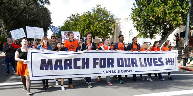People participate in a March for Our Lives event, Saturday, March 24, 2018, in San Luis Obispo, Calif.