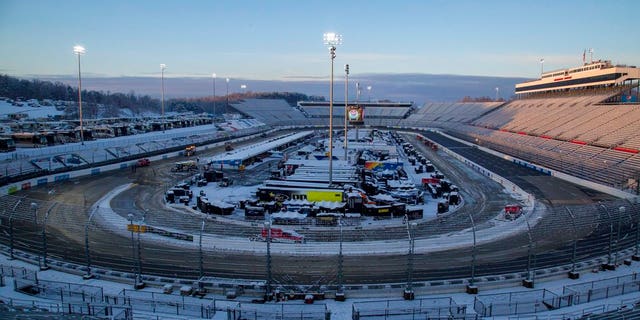 Snow rests on the ground at Martinsville Speedway in Martinsville, Va., Sunday, March 25, 2018. The NASCAR Cup Series race at Martinsville Speedway was postponed until Monday because of inclement weather. (AP Photo/Matt Bell)