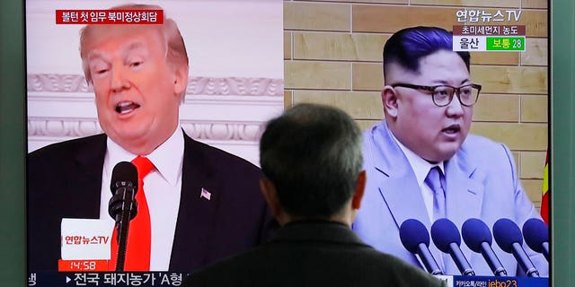 A man watches a TV screen showing file images of U.S. President Donald Trump, left, and North Korean leader Kim Jong Un, right, during a news program at the Seoul Railway Station in Seoul, South Korea, Tuesday, March 27, 2018.