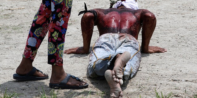 Thousands of Filipino Roman Catholic devotees and tourists descended Friday on a farming village north of Manila to witness the crucifixion of several men in a reenactment of Jesus Christ's sufferings, a gory annual tradition church leaders frown upon.
