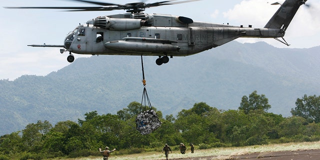 In this Saturday Oct. 10, 2009, file photo, a U.S. military helicopter, the CH-53E Super Stallion, airlifts humanitarian aid to be dropped in affected regions around Pariaman, north of Padang, Indonesia. On Tuesday, April 3, a CH-53E Super Stallion similar to the one shown went down during a training mission near El Centro, Calif., a few miles from the U.S.-Mexico border.