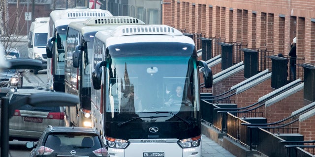 Buses believed to be carrying expelled diplomats prepare to leave the U.S. Embassy in Moscow, Russia, Thursday, April 5, 2018.