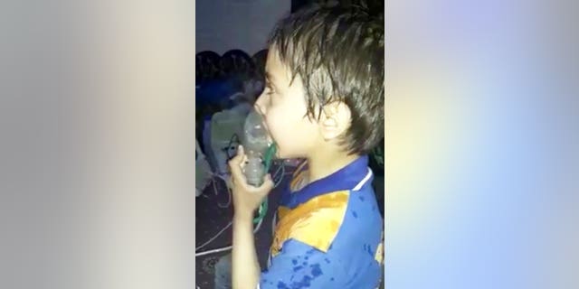 This image made from video released by the Syrian Civil Defense White Helmets shows a toddler given oxygen through respirators following an alleged poison gas attack.