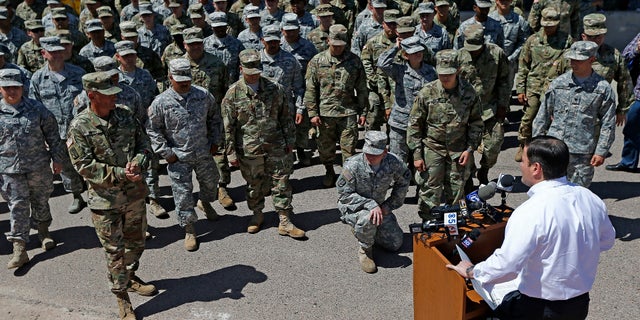 Arizona Gov. Doug Ducey speaks to Arizona National Guard soldiers prior to deployment to the Mexico border on April 9, 2018.