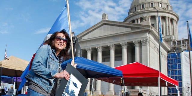Leaders of Oklahoma's largest teacher's union have demanded a repeal of a capital gains tax exemption and for the governor to veto a repeal of a proposed lodging tax as they push for more education funding in massive demonstrations at the state Capitol, Tuesday, April 10, 2018, in Oklahoma City.