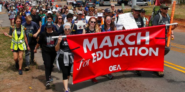 Demonstrators in Oklahoma on the final leg of a 110-mile trip from Tulsa to the state Capitol as protests continue over school funding, in Oklahoma City, Tuesday, April 10, 2018.
