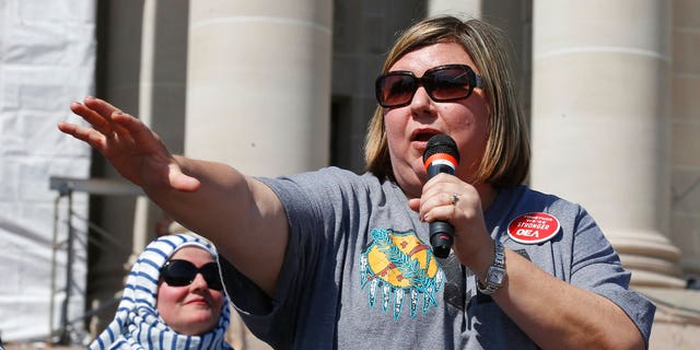 Alicia Priest, president of the Oklahoma Education Association, speaks to a crowd of teachers and supporters following the arrival of a group that walked 110 miles from Tulsa to the state Capitol as protests continue over school funding, in Oklahoma City, Tuesday, April 10, 2018.