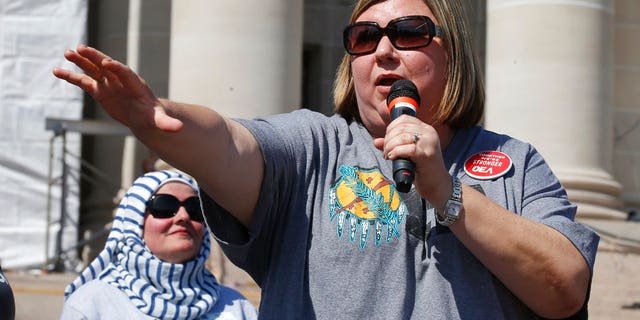 Alicia Priest, president of the Oklahoma Education Association, speaks to a crowd of teachers and supporters following the arrival of a group that walked 110 miles from Tulsa to the state Capitol as protests continue over school funding, in Oklahoma City, Tuesday, April 10, 2018.