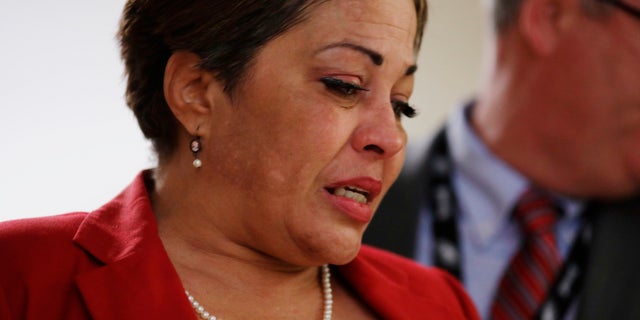 Chelan Lasha weeps as she returns to the courtroom after recess to testify against Bill Cosby during Cosby's sexual assault retrial.