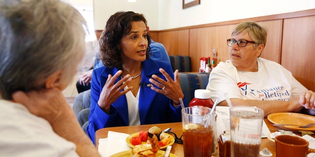 In this photo, Dr. Hiral Tipirneni talks with supporters at a local restaurant in Sun City, Arizona.