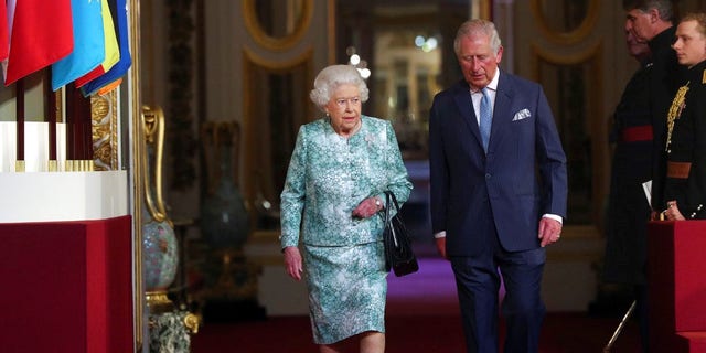 Britain's Queen Elizabeth II and Prince Charles arrive for the formal opening of the Commonwealth Heads of Government Meeting at Buckingham Palace in London, Thursday April 19, 2018. (Jonathan Brady/Pool via AP)