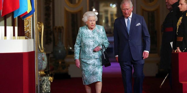 Britain's Queen Elizabeth II and Prince Charles arrive for the formal opening of the Commonwealth Heads of Government Meeting at Buckingham Palace in London, Thursday April 19, 2018. (Jonathan Brady/Pool via AP)