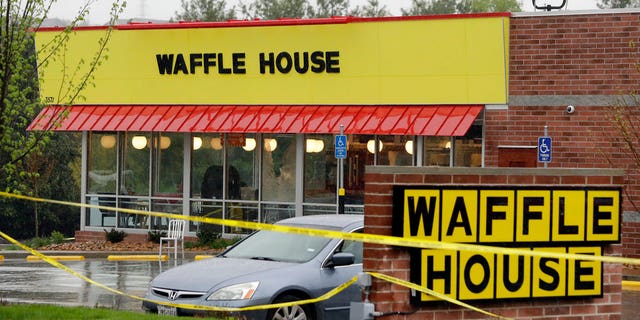 Police tape blocks off a Waffle House restaurant Sunday, April 22 in Tennessee.