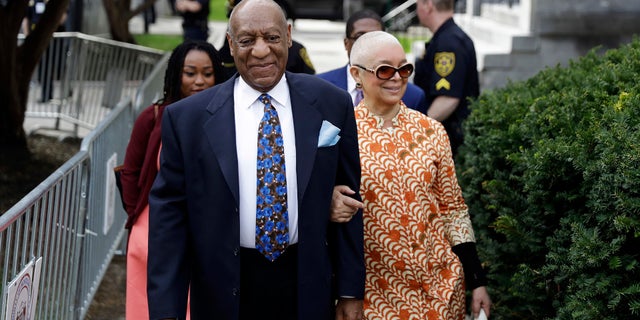 Bill Cosby and his wife, Camille, walking into court.