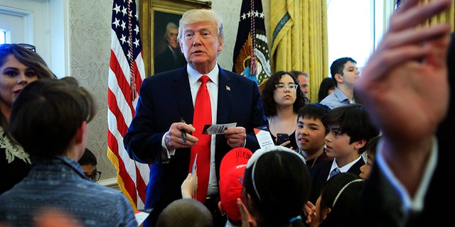 President Trump signed hats and press credentials for the kids.