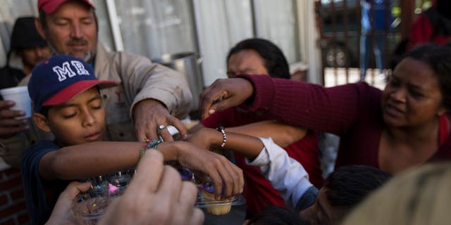 Migrants have their breakfast at a shelter in Tijuana, Mexico, April 28, 2018.