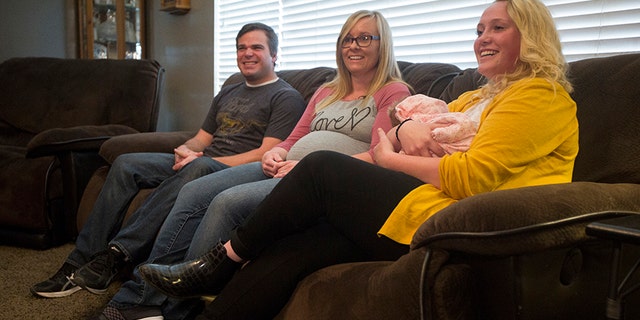 From left to right, Wendell and Laura Creager and Morlie Hayes, seen holding newborn baby, Kayla.