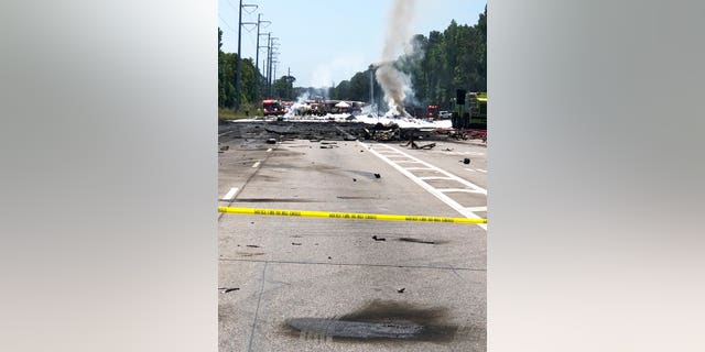 Emergency personnel work at the scene of an Air National Guard WC-130 cargo plane that crashed near Savannah, Ga., Wednesday, May 2, 2018.