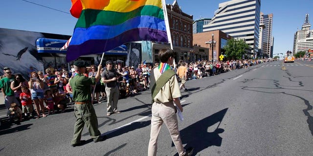 In this July 8, 2014 photo, a group of Boy Scouts march during the Salt Lake City's annual gay pride parade in Salt Lake City, Utah.