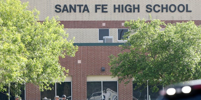 Law enforcement officers respond to Santa Fe High School after an active shooter was reported on campus on Friday.