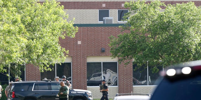 Law enforcement officers respond to Santa Fe High School after an active shooter was reported on campus on Friday.