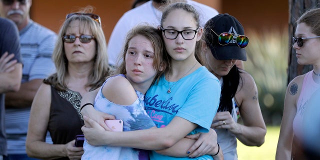 Mourners wait for the start of a prayer vigil following a deadly shooting at Santa Fe High School in Santa Fe, Texas, on Friday, May 18, 2018.