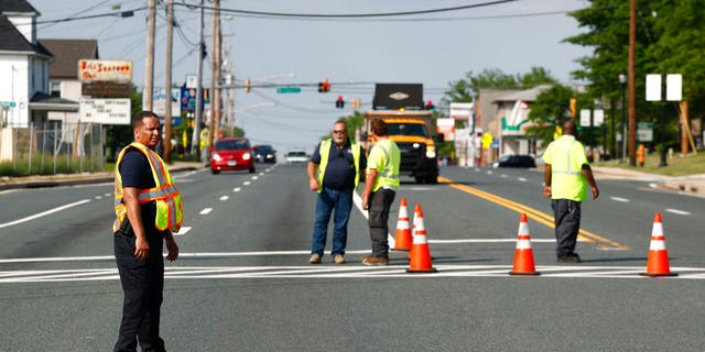 Officials guard a roadblock near a scene where a Baltimore County police officer died, while investigating a suspicious vehicle, Monday, May 21, 2018, in Perry Hall, Md.