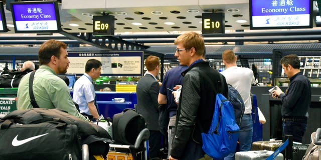 Foreign journalists at Beijing airport to board the flight to North Korea.