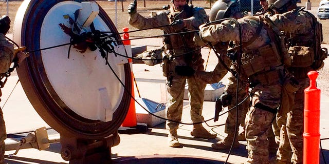 In this February 2016 photo, members of the 790th Missile Security Forces Squadron demonstrate their training for recapturing a Minuteman missile silo after being taken over by an intruder/attacker, just days before the Air Force announced the drug investigation, at the Francis E. Warren Air Force Base, near Cheyenne, Wyo.