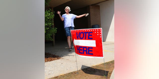 Cindy Benton celebrates after voting in the Arkansas primary election on Tuesday, May 22, 2018 in Little Rock, Ark. The Democratic and Republican parties held elections Tuesday, while all registered voters were allowed to vote in judicial elections.