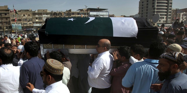 People carry the coffin of Sabika Sheikh, the Pakistani exchange student killed in a mass shooting at a high school in Texas, after offering funeral prayers in Karachi, Pakistan, Wednesday, May 23, 2018. Her body has arrived in the port city of Karachi, where her family lived and where she isbeing buried. (AP Photo/Fareed Khan)