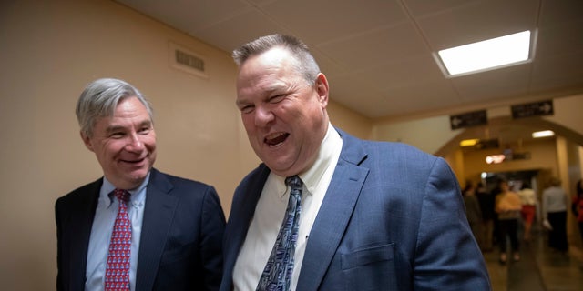 Sen. Jon Tester (right) leaves the Capitol following votes.