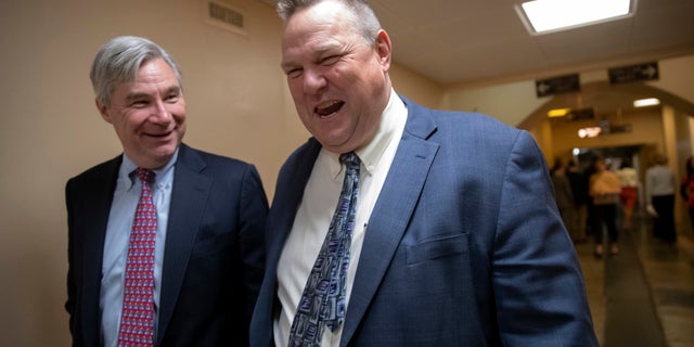 Sen. Jon Tester (right) leaves the Capitol following votes.