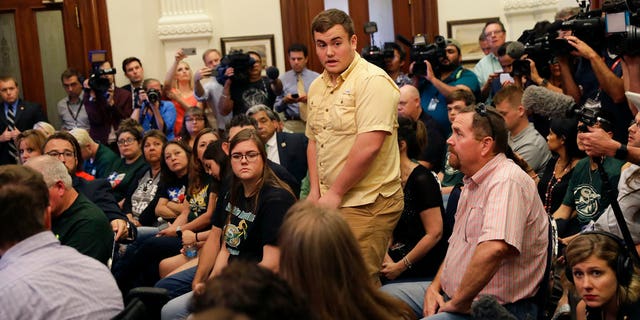 Tyler Morrison, center, a student at Santa Fe High School in Santa Fe, Texas, speaks during a roundtable discussion on gun violence, in Austin, Texas, May 24, 2018.