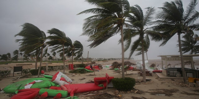 Debris litter a beach after Cyclone Mekunu in Salalah, Oman, Saturday, May 26, 2018. Cyclone Mekunu blew into the Arabian Peninsula early Saturday, drenching arid Oman and Yemen with rain, cutting off power lines, officials said. (AP Photo/Kamran Jebreili)