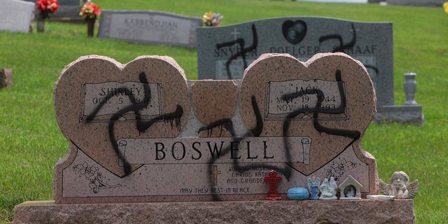 May 26, 2018: Grave markers with swastikas spray-painted on them stand in the Sunset Hill Cemetery in in Glen Carbon, Ill.