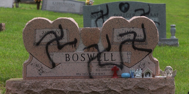 May 26, 2018: Grave markers with swastikas spray-painted on them stand in the Sunset Hill Cemetery in in Glen Carbon, Ill.
