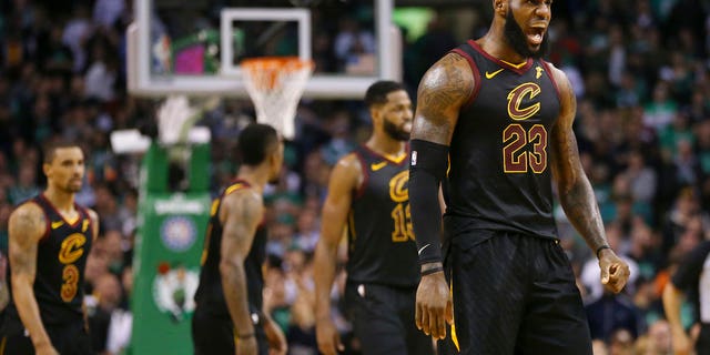 Cleveland Cavaliers forward LeBron James, right, celebrates a basket during the second half in Game 7 of the NBA basketball Eastern Conference finals against the Boston Celtics